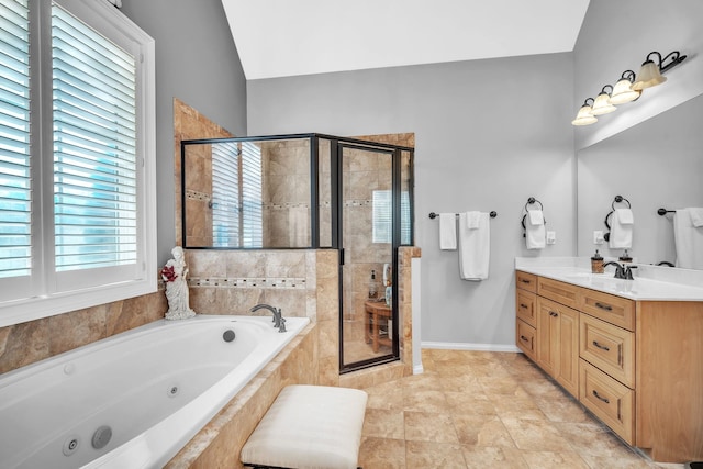 bathroom with vanity, vaulted ceiling, shower with separate bathtub, and tile patterned flooring