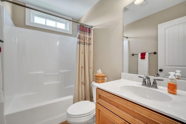 full bathroom with vanity, shower / tub combo, and toilet