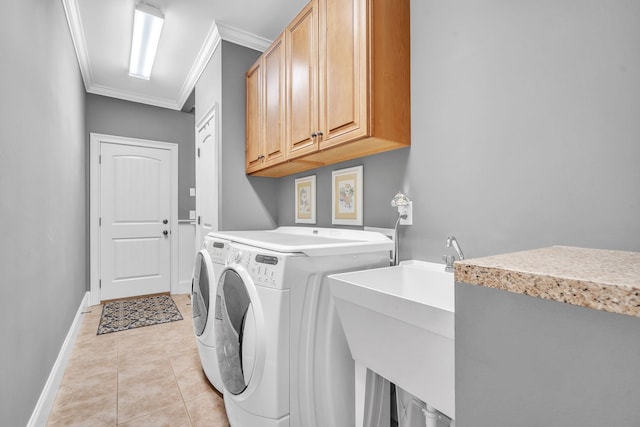 laundry room featuring crown molding, light tile patterned flooring, cabinets, and independent washer and dryer