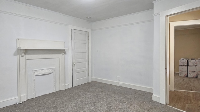 interior space with crown molding and dark colored carpet