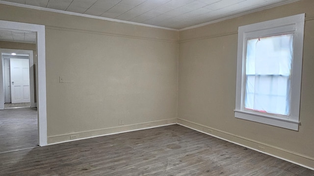 spare room with crown molding and dark hardwood / wood-style flooring