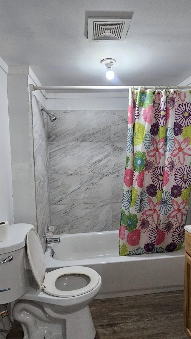 full bathroom featuring vanity, toilet, hardwood / wood-style flooring, and shower / tub combo with curtain