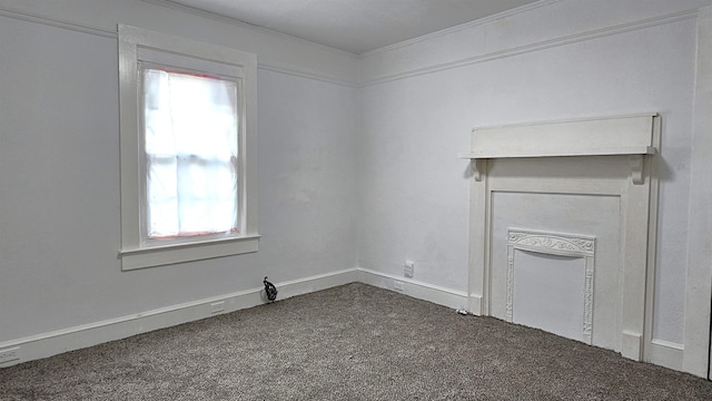 carpeted spare room with crown molding and a healthy amount of sunlight