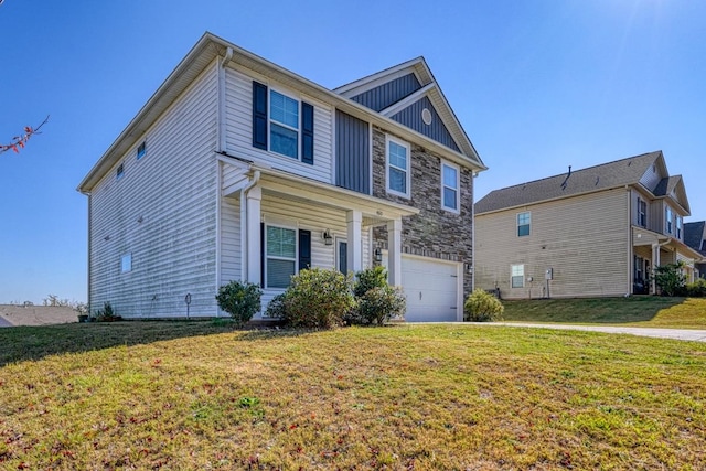 view of front of home featuring a front yard and a garage