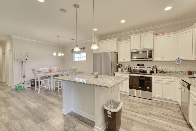 kitchen featuring appliances with stainless steel finishes, a center island, pendant lighting, and white cabinets