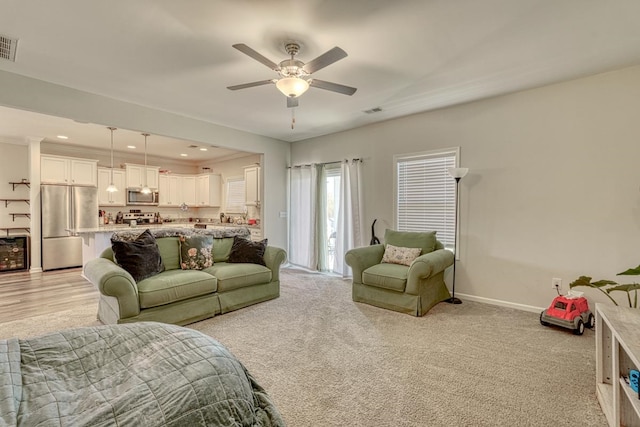 living room with light carpet and ceiling fan