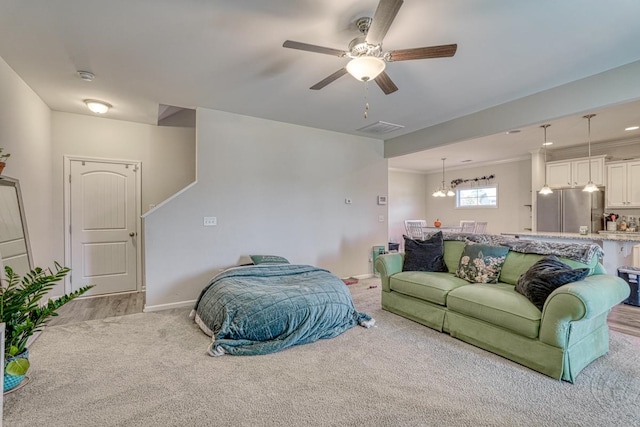 carpeted living room with ornamental molding and ceiling fan with notable chandelier