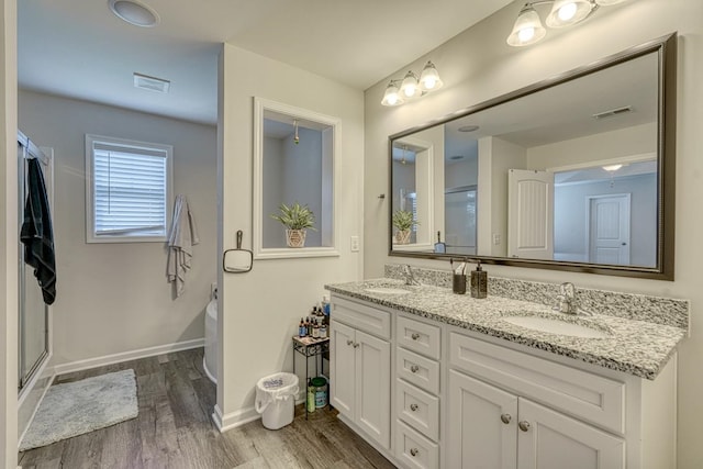 bathroom featuring vanity, independent shower and bath, and hardwood / wood-style flooring