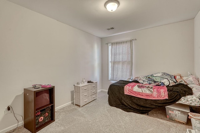 bedroom featuring light colored carpet