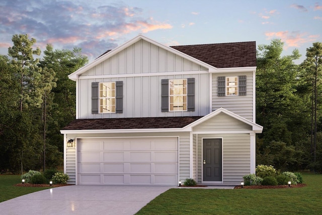 view of front of house with a yard and a garage