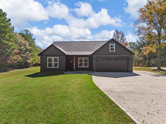 ranch-style home with a front yard and a garage