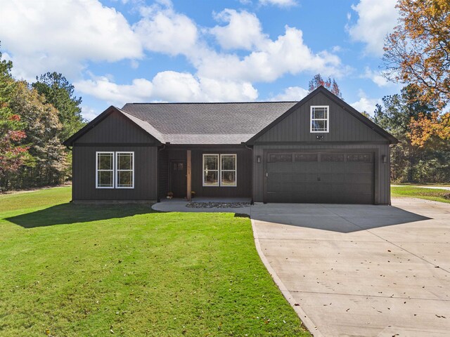 ranch-style home with a front yard and a garage