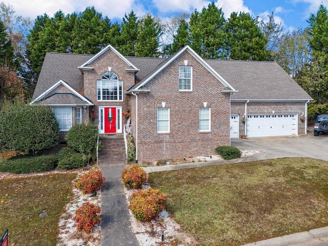 front facade with a front yard and a garage