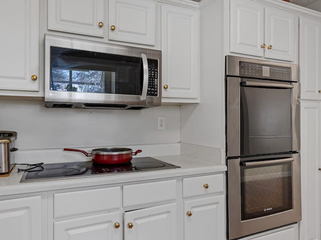 kitchen with white cabinetry and stainless steel appliances