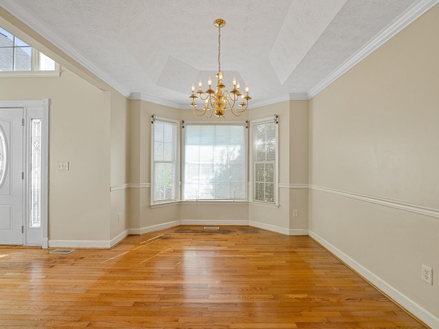 interior space with crown molding, a textured ceiling, and light wood-type flooring