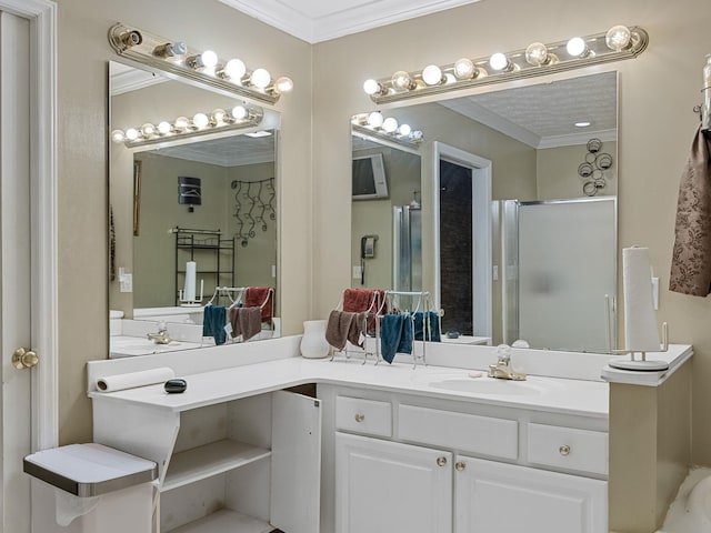 bathroom with vanity, ornamental molding, and an enclosed shower