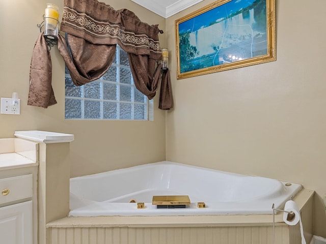 bathroom featuring vanity, ornamental molding, and a bath