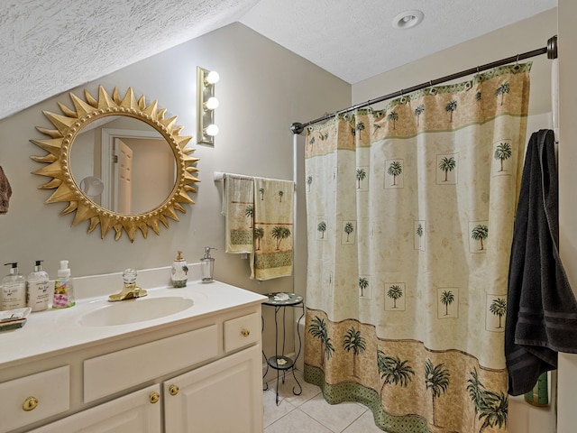 bathroom featuring tile patterned flooring, vaulted ceiling, vanity, a textured ceiling, and walk in shower