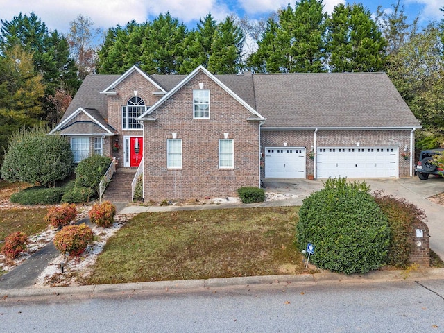 view of property with a front lawn and a garage