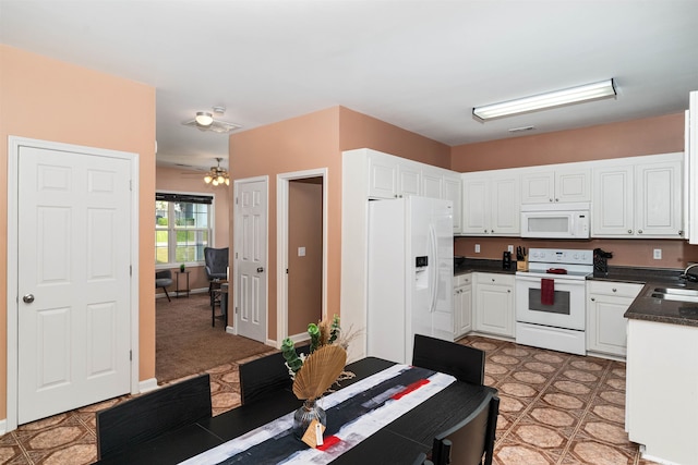 kitchen featuring white appliances, ceiling fan, white cabinetry, and sink