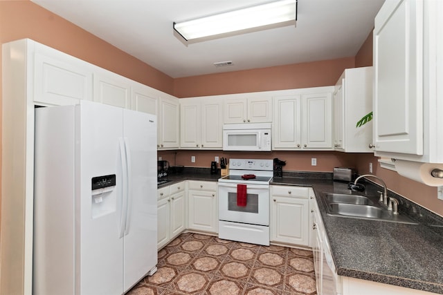 kitchen with sink, white cabinets, and white appliances