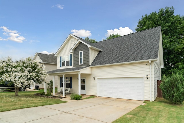 view of front of house featuring a porch, a front lawn, and a garage