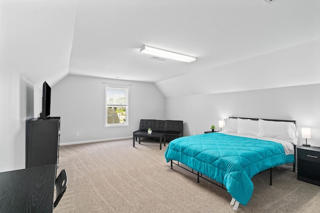 carpeted bedroom with lofted ceiling