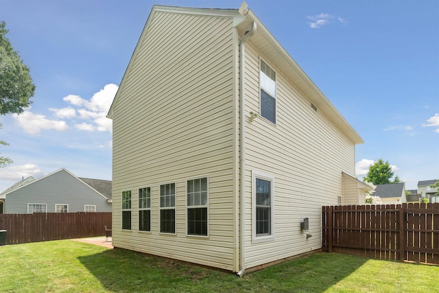 rear view of house featuring a yard