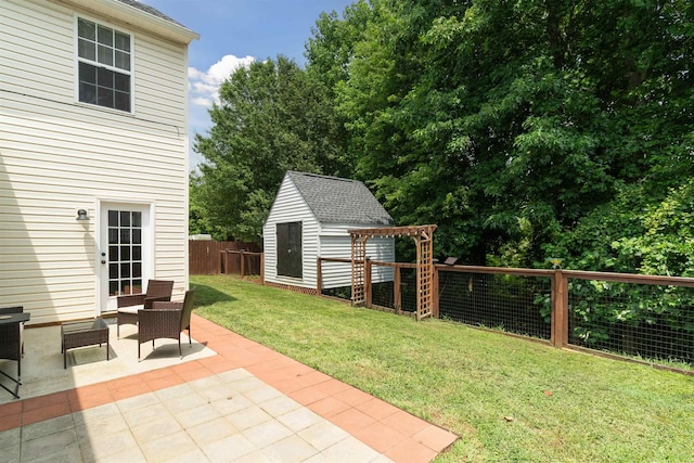 view of yard featuring a patio and a shed