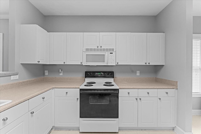 kitchen with white cabinetry, range with electric cooktop, and light tile patterned flooring