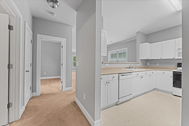 kitchen featuring sink, white cabinetry, light carpet, and white appliances