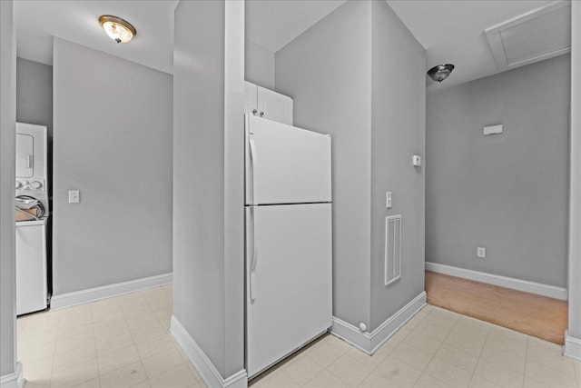 bathroom featuring stacked washer / dryer