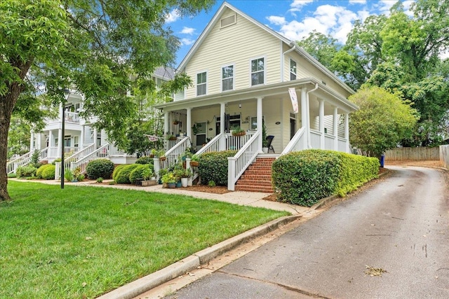 view of front of property with a front yard and a porch