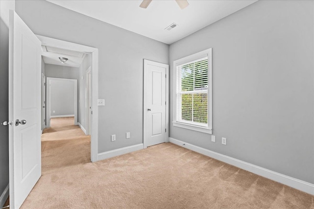 unfurnished bedroom with ceiling fan and light carpet