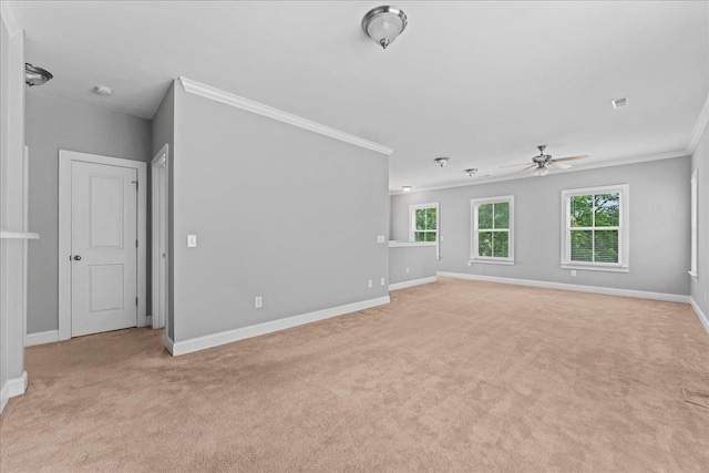 unfurnished living room with crown molding, light colored carpet, and ceiling fan