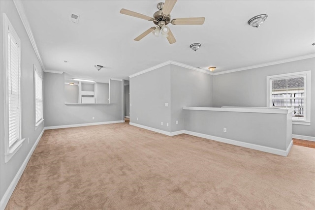 unfurnished living room with crown molding, light colored carpet, and ceiling fan