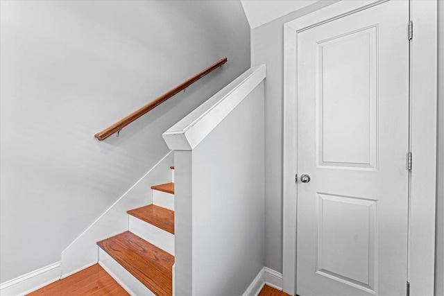 stairs featuring hardwood / wood-style flooring