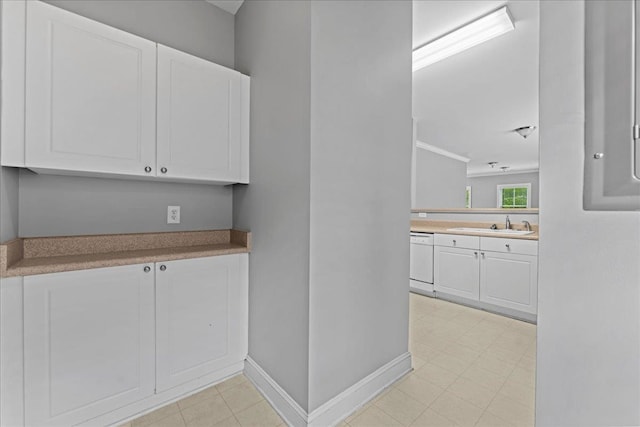 kitchen featuring white cabinetry, white dishwasher, and sink