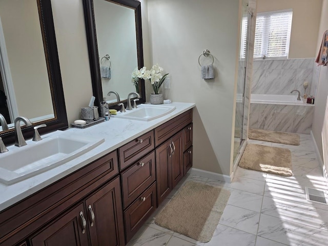 bathroom with vanity and independent shower and bath