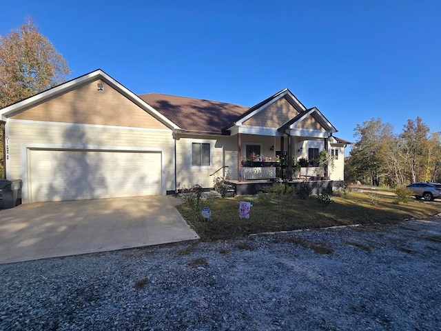 view of front of home with covered porch and a garage