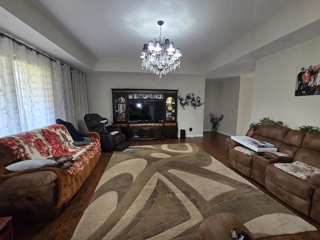 living room featuring a chandelier and dark hardwood / wood-style flooring