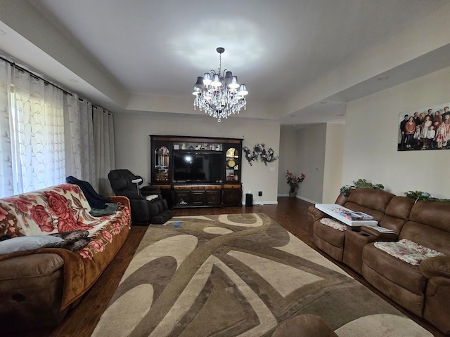 living room with a notable chandelier and dark hardwood / wood-style floors