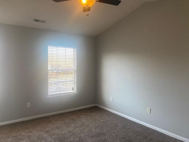 empty room featuring ceiling fan, carpet, and vaulted ceiling