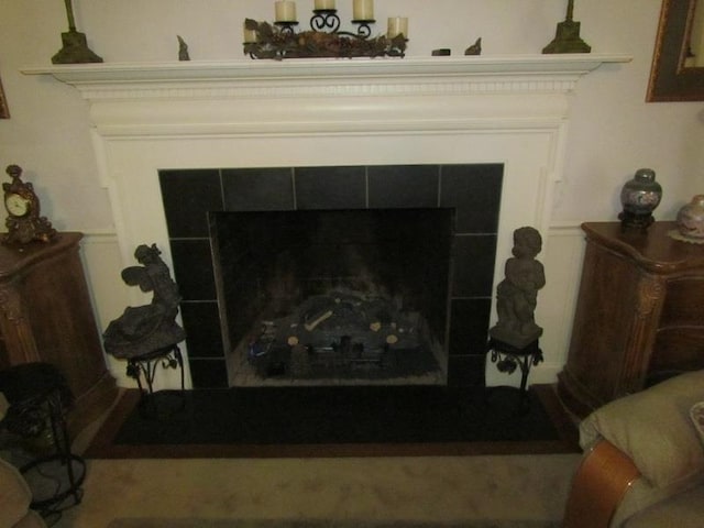 interior details with a tile fireplace