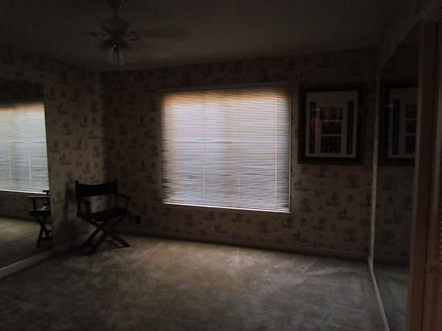 interior space with carpet flooring and ceiling fan