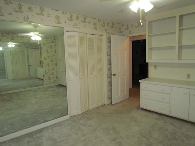 unfurnished bedroom with light carpet and ceiling fan