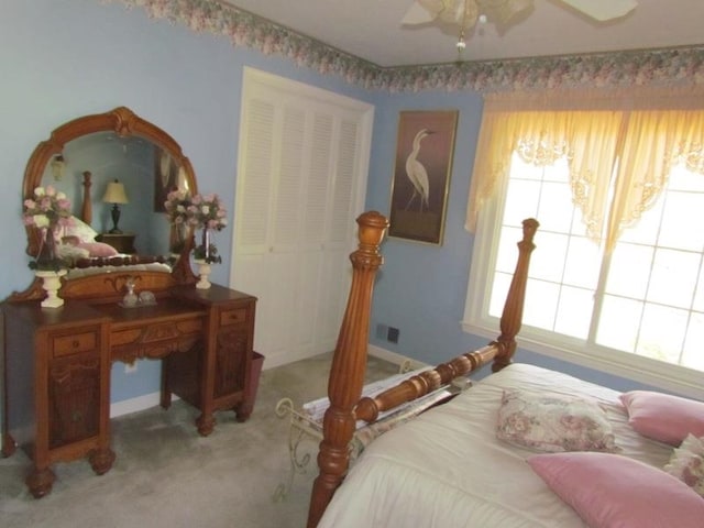 carpeted bedroom featuring a closet and ceiling fan