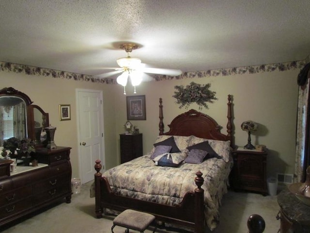 carpeted bedroom featuring a textured ceiling and ceiling fan