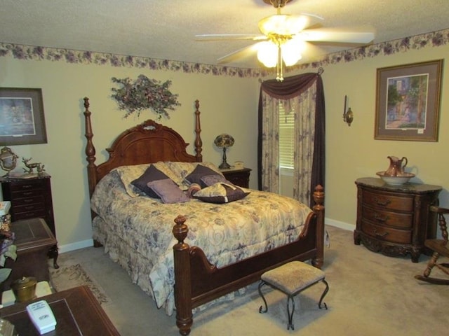 carpeted bedroom featuring a textured ceiling and ceiling fan