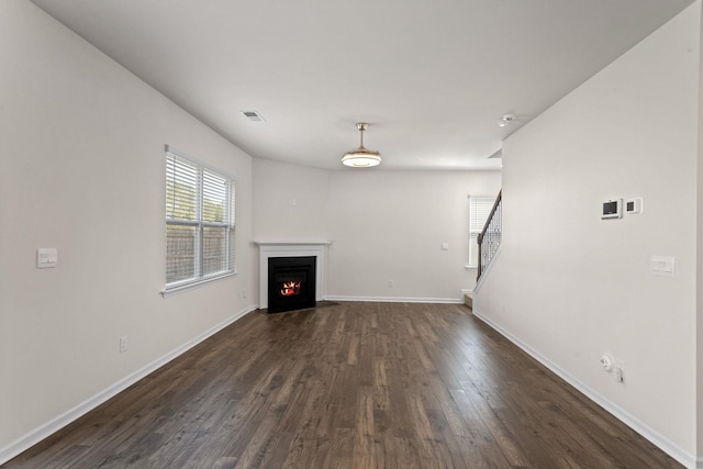 unfurnished living room with dark hardwood / wood-style flooring